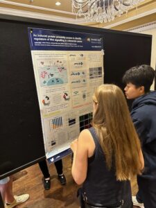 Lucie discussing her poster at the 2023 Donnelly Retreat.