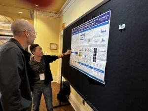 Andy discussing his poster at the 2023 Donnelly summer Retreat.